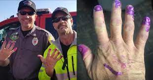 Firefighters calm down scared little girl at crash scene by asking her to paint their nails